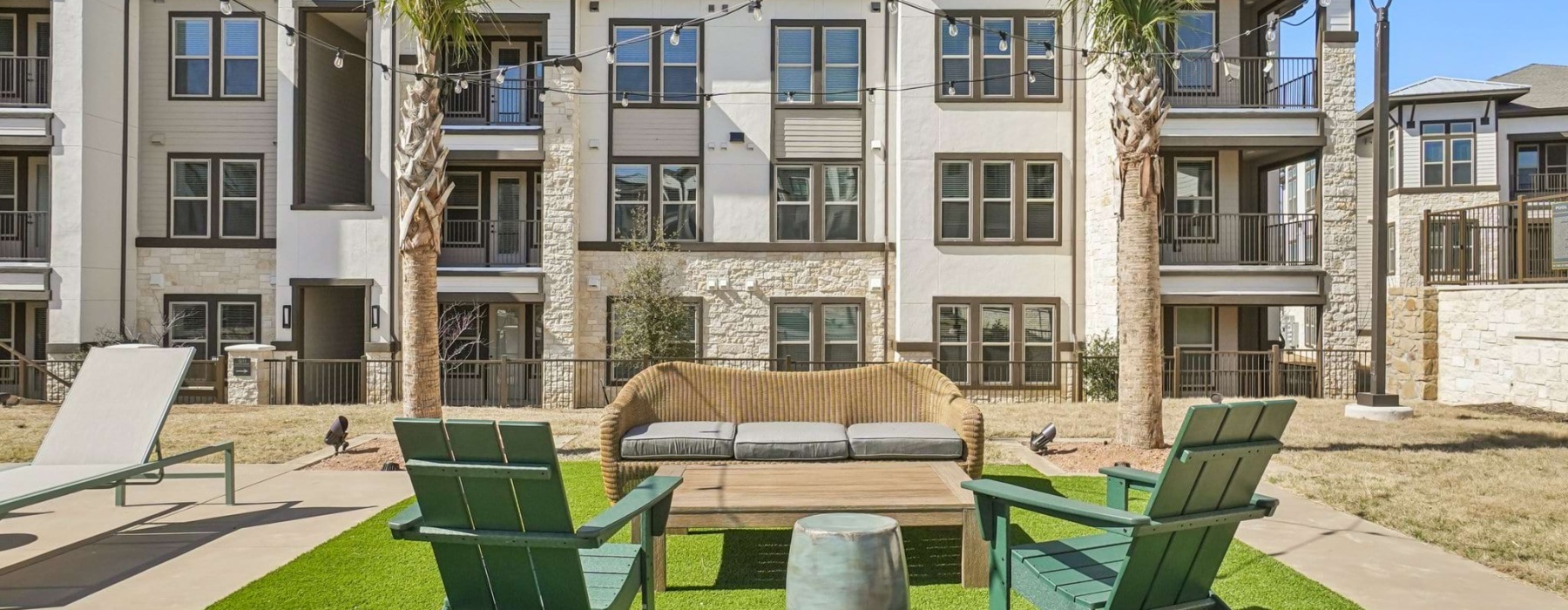 Outdoor lounge with Adirondack chairs at The Waldon apartments in Melissa, TX
