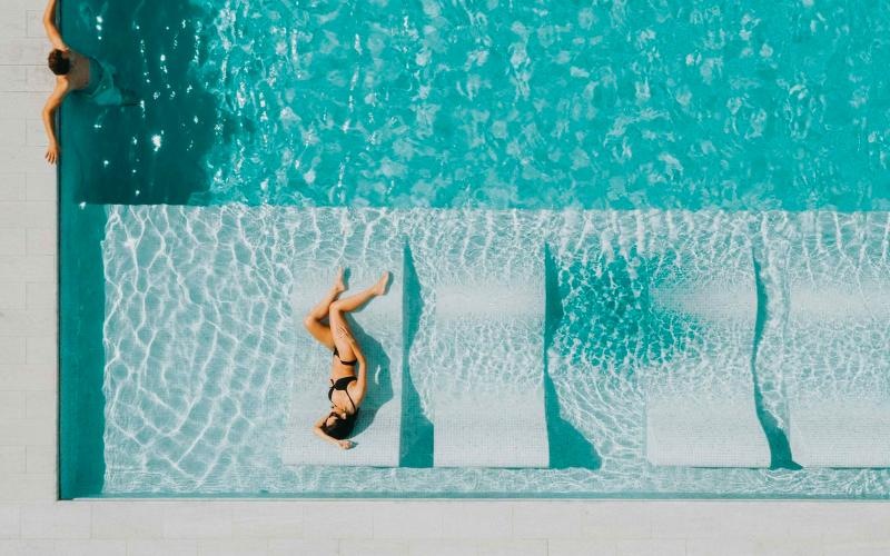 a group of people swimming in a pool