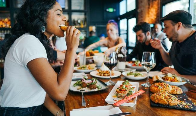 Vibrant community life with a variety of dining options a person eating food at a restaurant